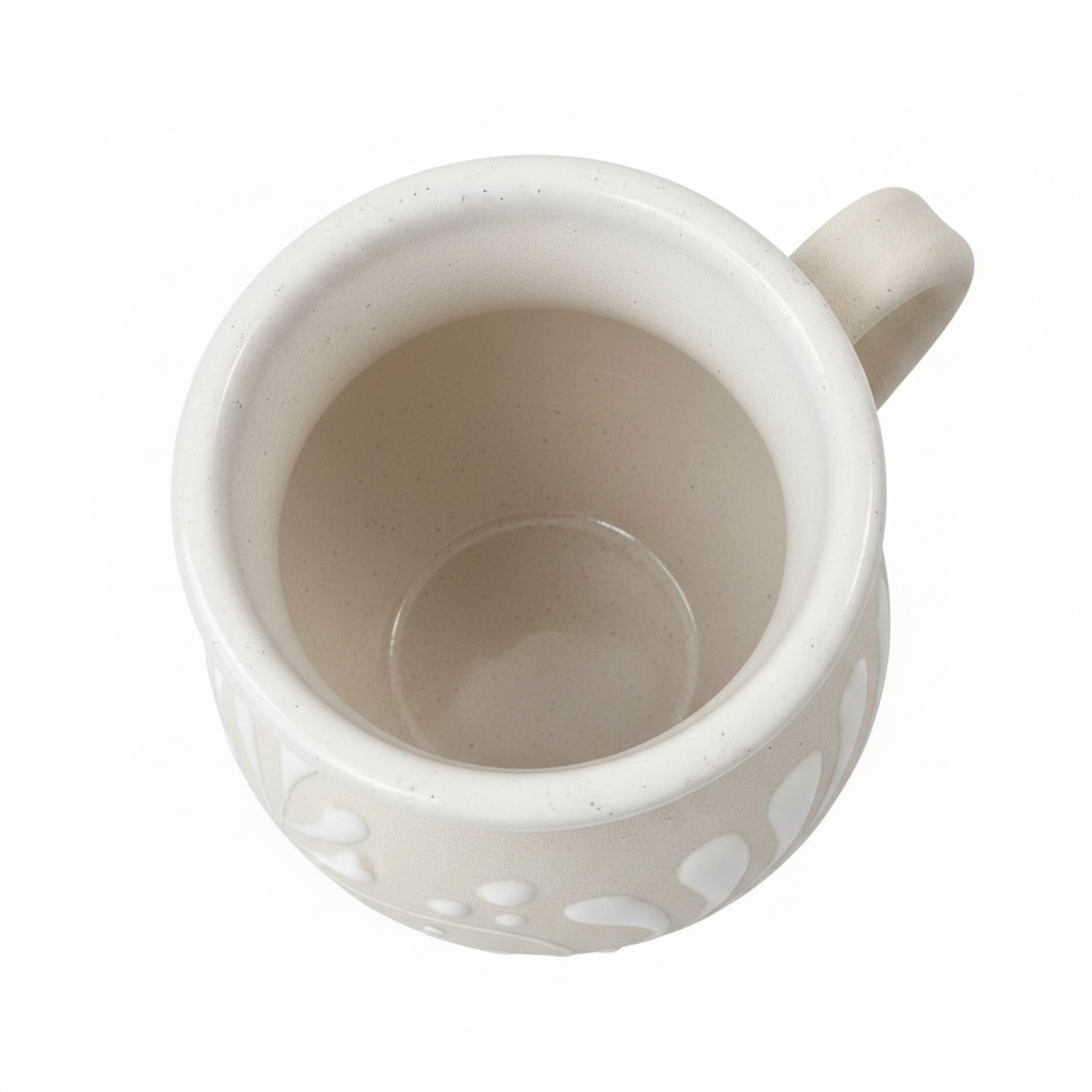 White ceramic mug with decorative patterns on a white background