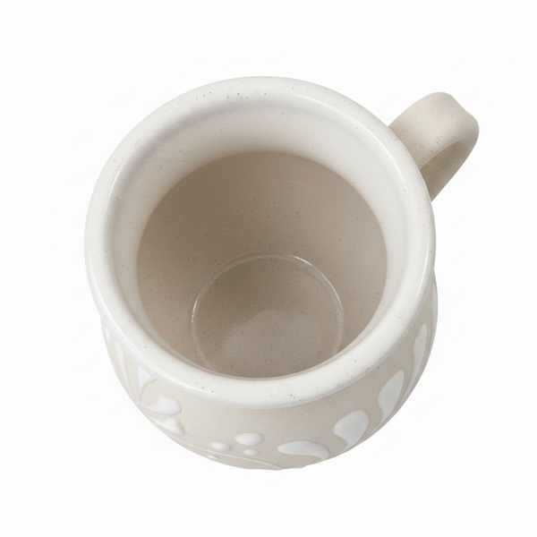 White ceramic mug with decorative patterns on a white background