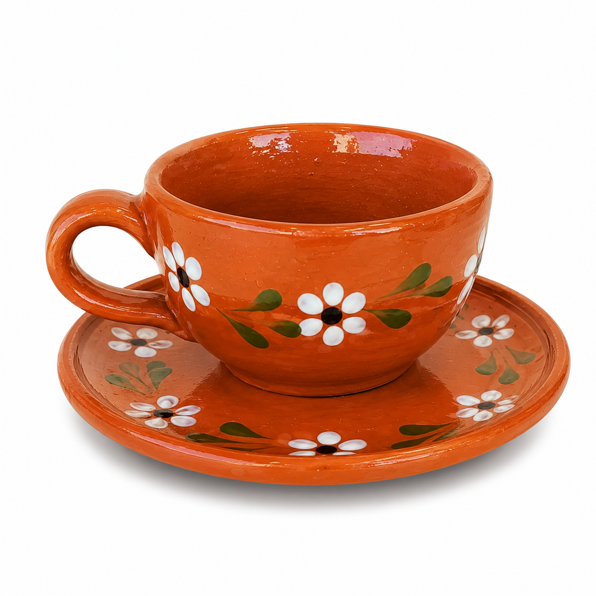 Ceramic cup and saucer with floral design on a white background