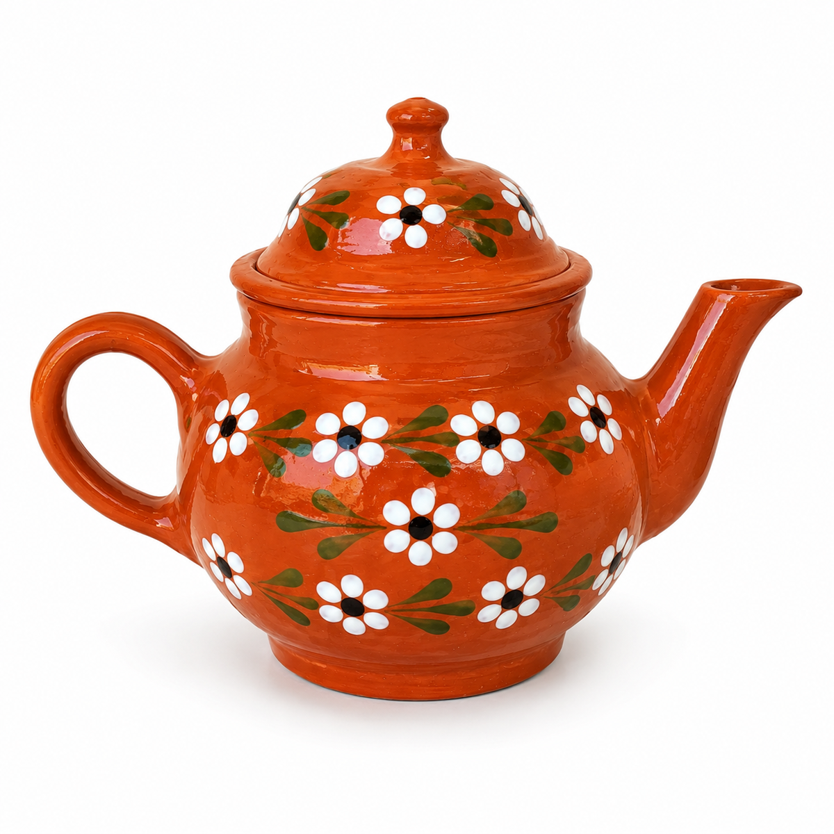 Orange teapot with floral patterns on a white background