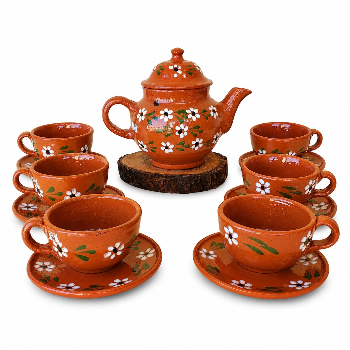 Ceramic tea set with teapot and cups on a white background