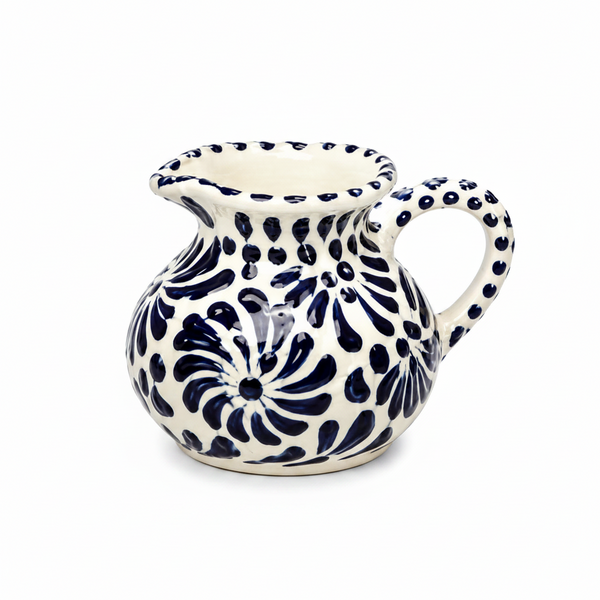 Ceramic pitcher with blue floral patterns on a white background