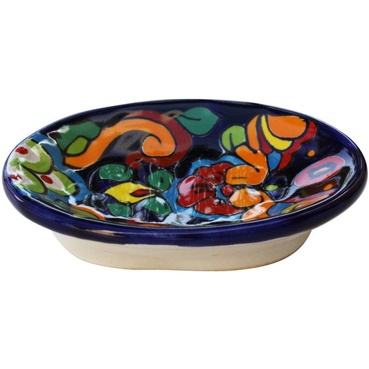 A round hand-painted ceramic dish with a dark blue rim and a colorful, abstract floral and leaf pattern in orange, green, red, yellow, and pink on a white base, shown against a plain white background.