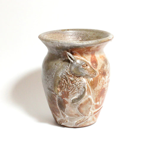 Ceramic vase with a deer design on a white background
