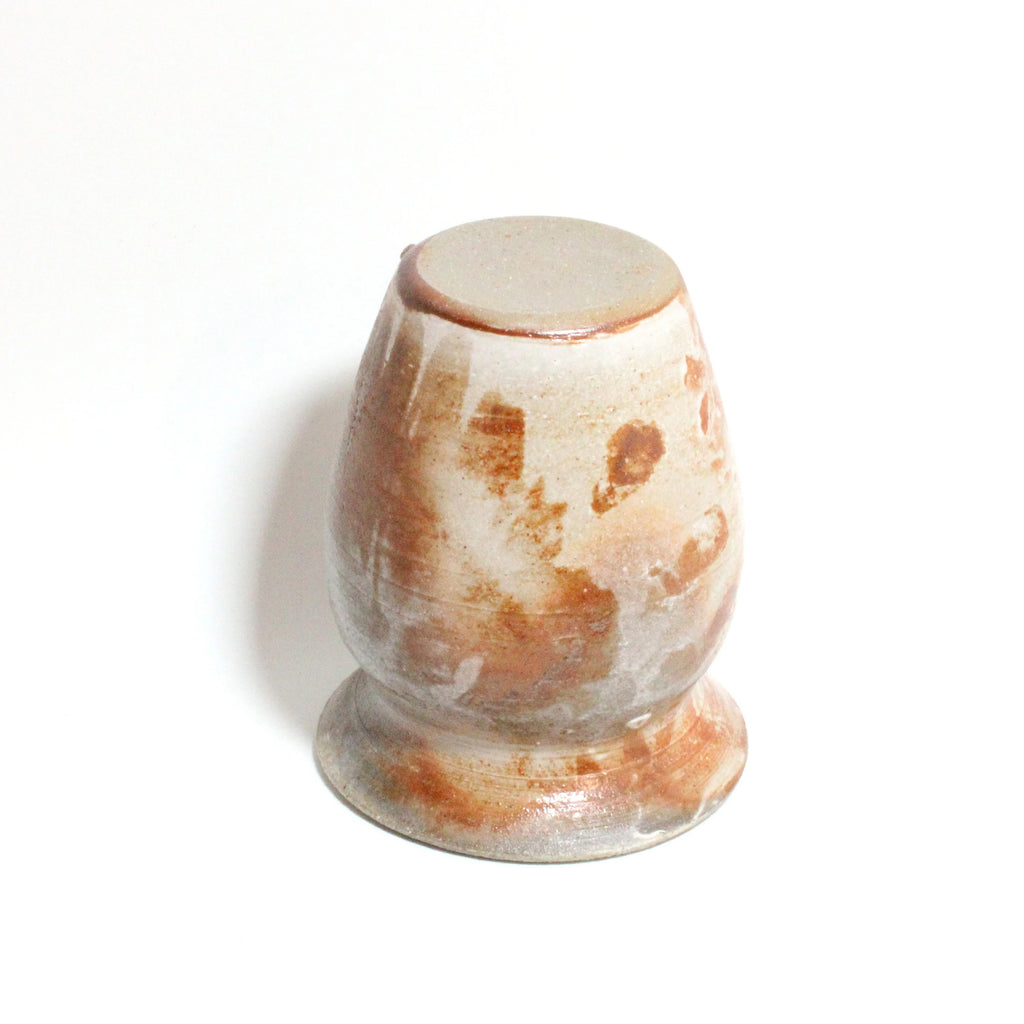 Decorative stone with brown and white patterns on a white background