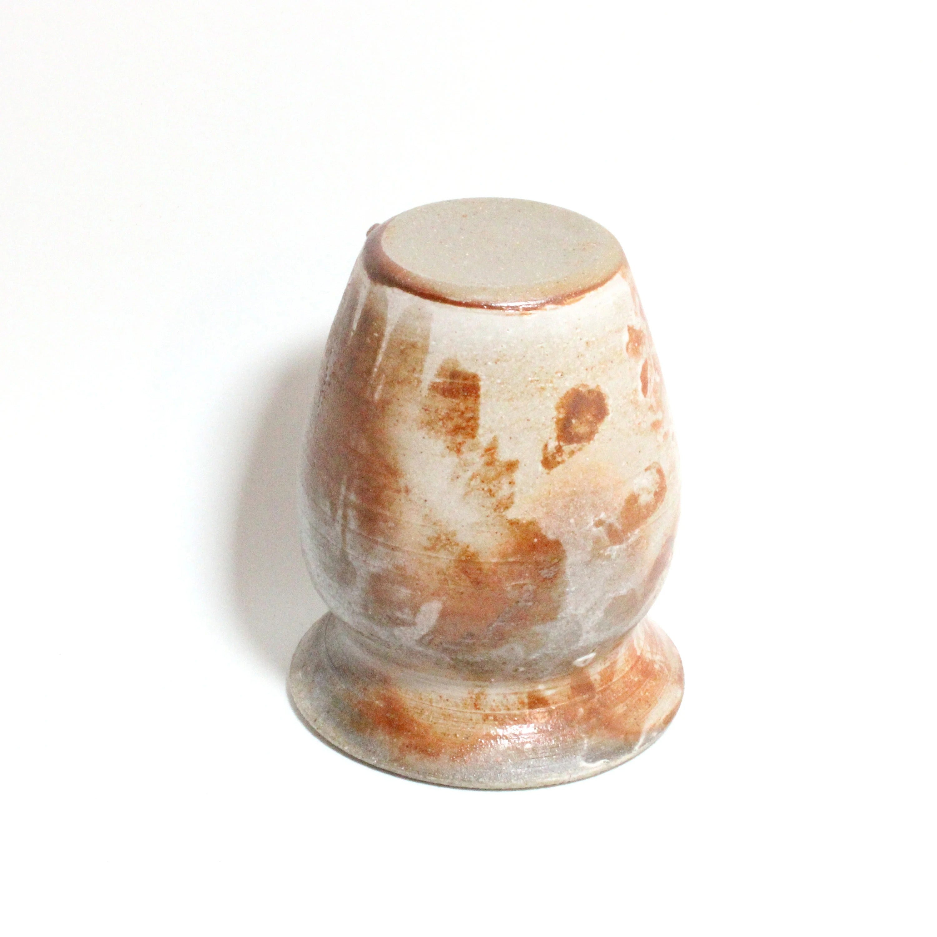 Decorative stone with brown and white patterns on a white background