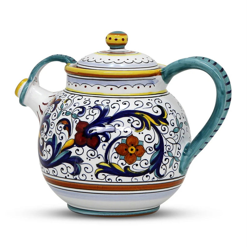 Decorative ceramic teapot with floral patterns on a white background