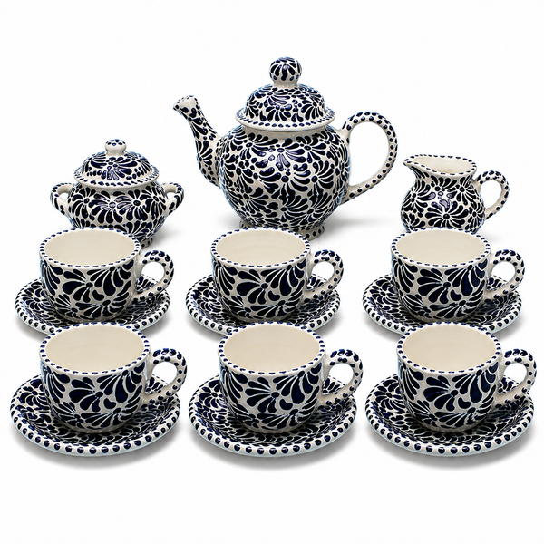 Ceramic tea set with black floral patterns on a white background