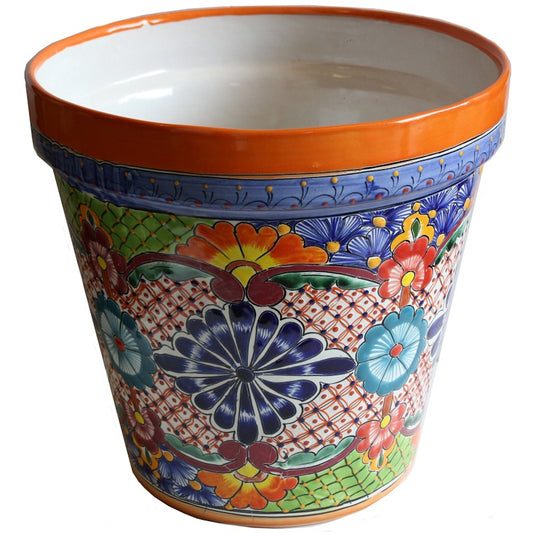 A hand-painted ceramic planter pot with a vibrant Mexican Talavera style design, featuring a terracotta orange rim, blue floral motifs, and a multicolor patterned body on a white background.
