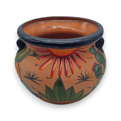 Ceramic pot with artistic designs on a white background