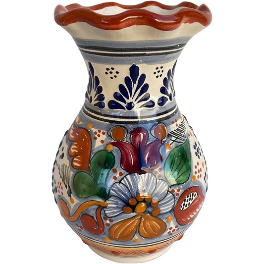 A hand-painted ceramic vase with a scalloped rim, featuring a colorful Talavera-style floral pattern on a cream background with blue, orange, green, and purple details.