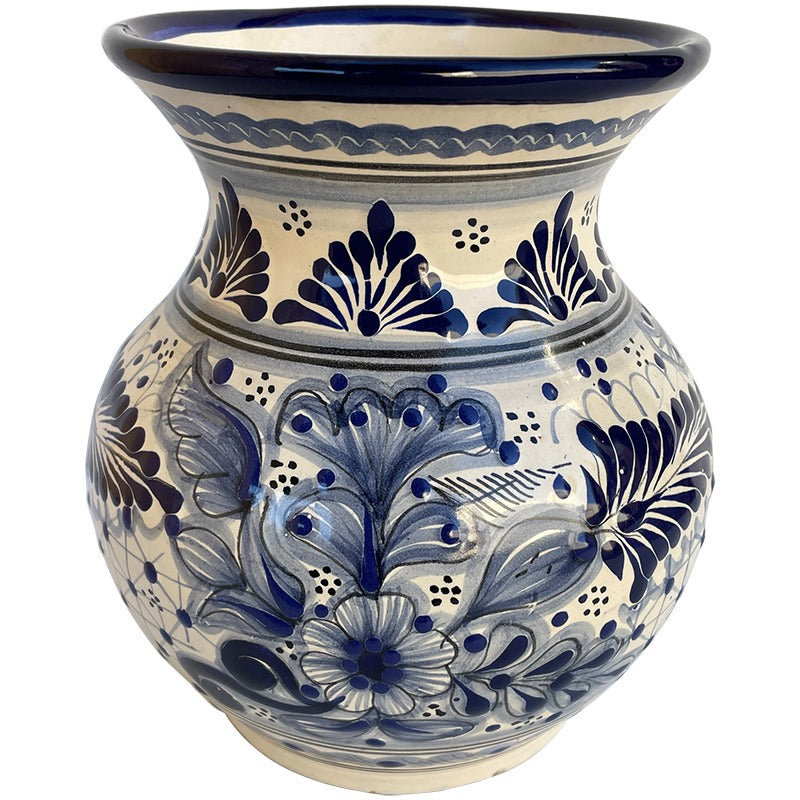 A ceramic planter pot with a blue and cream hand-painted floral pattern, featuring a wide flared rim and a rounded body, shown against a plain white background.